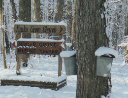 sign pointing directions to Sugar Grove and the Church